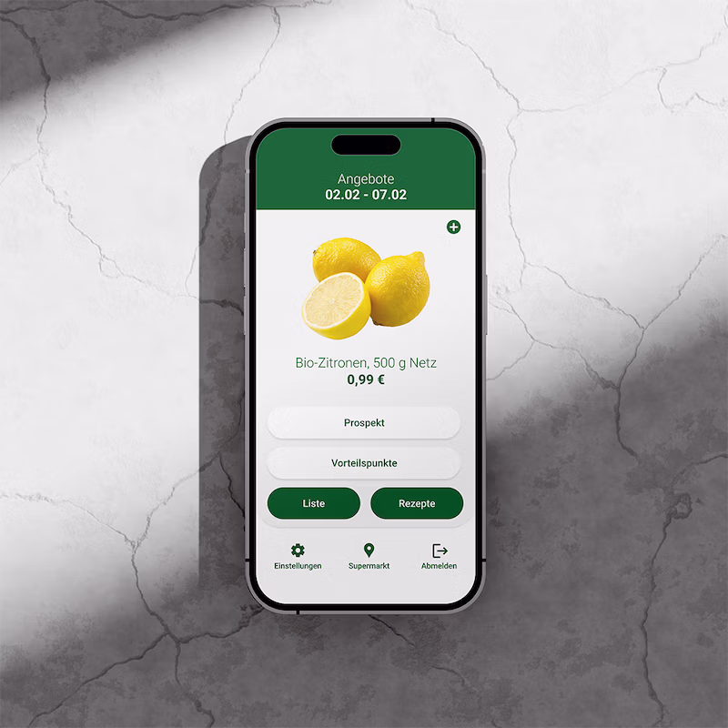 Ein Handy auf einer Marmor-Fläche. Auf dem Screen ist ein Oberfläche zu erkennen, die Zitronen darstellt, die Nutzer:innen dem Einkaufswagen beifügen können.